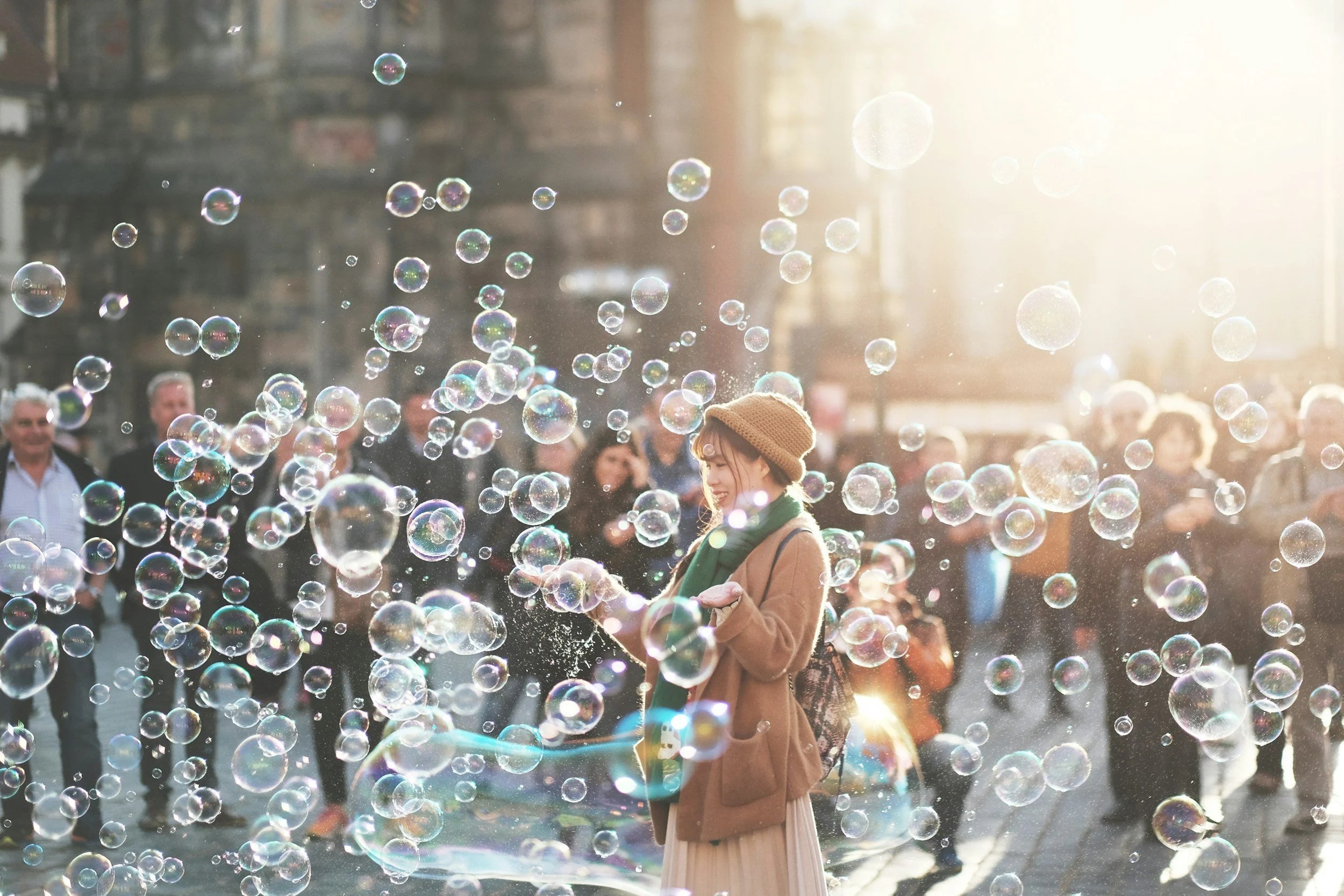 Woman in crowd with bubbles representing play and joy as resistance